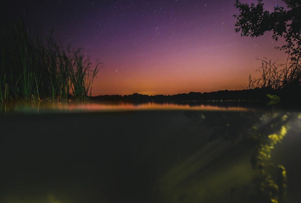 the night sky is reflected in the water - by Brittany Forest Lakes